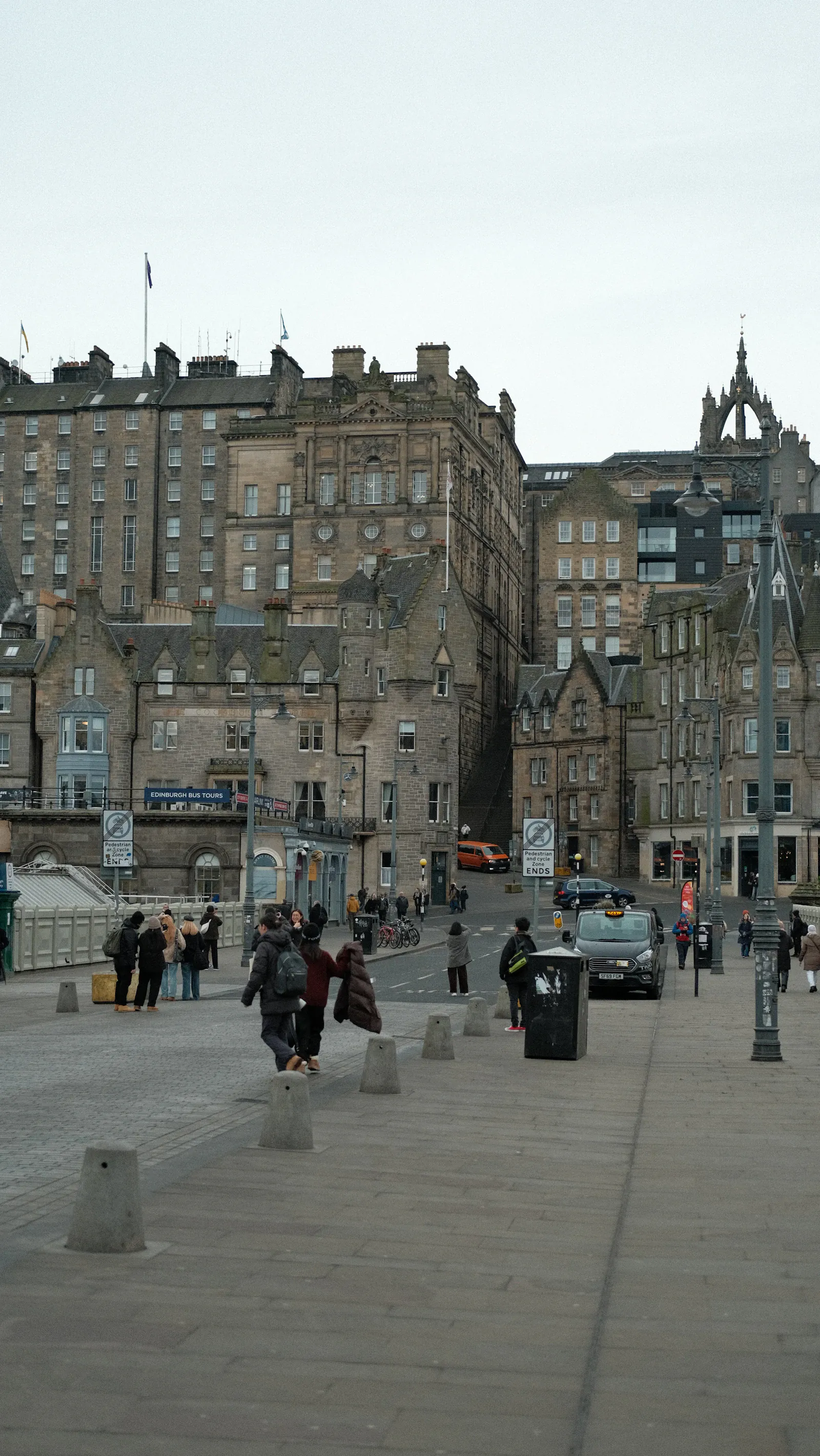 People walking along a historic Edinburgh street